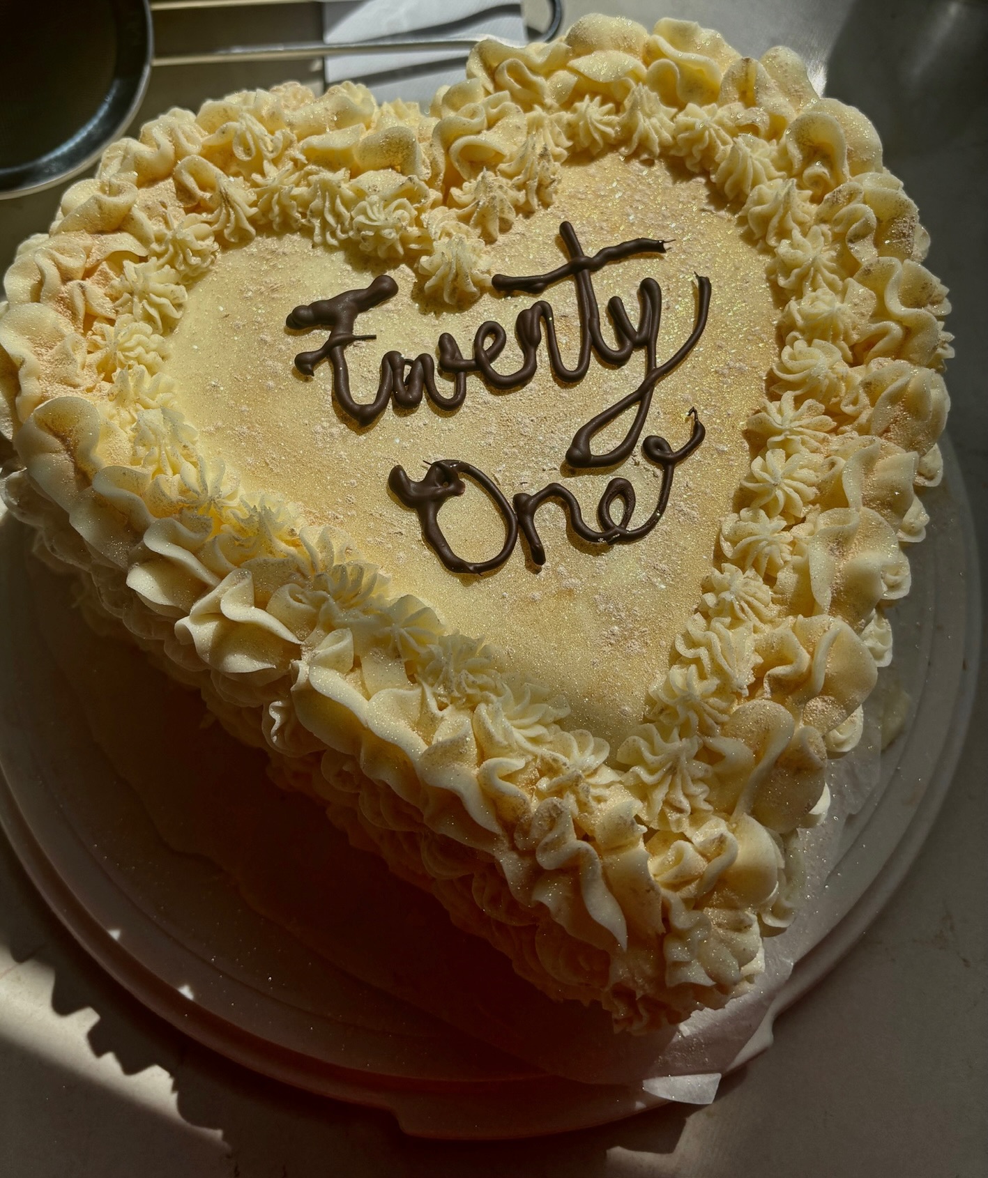 Heart-shaped birthday cake with chocolate lettering