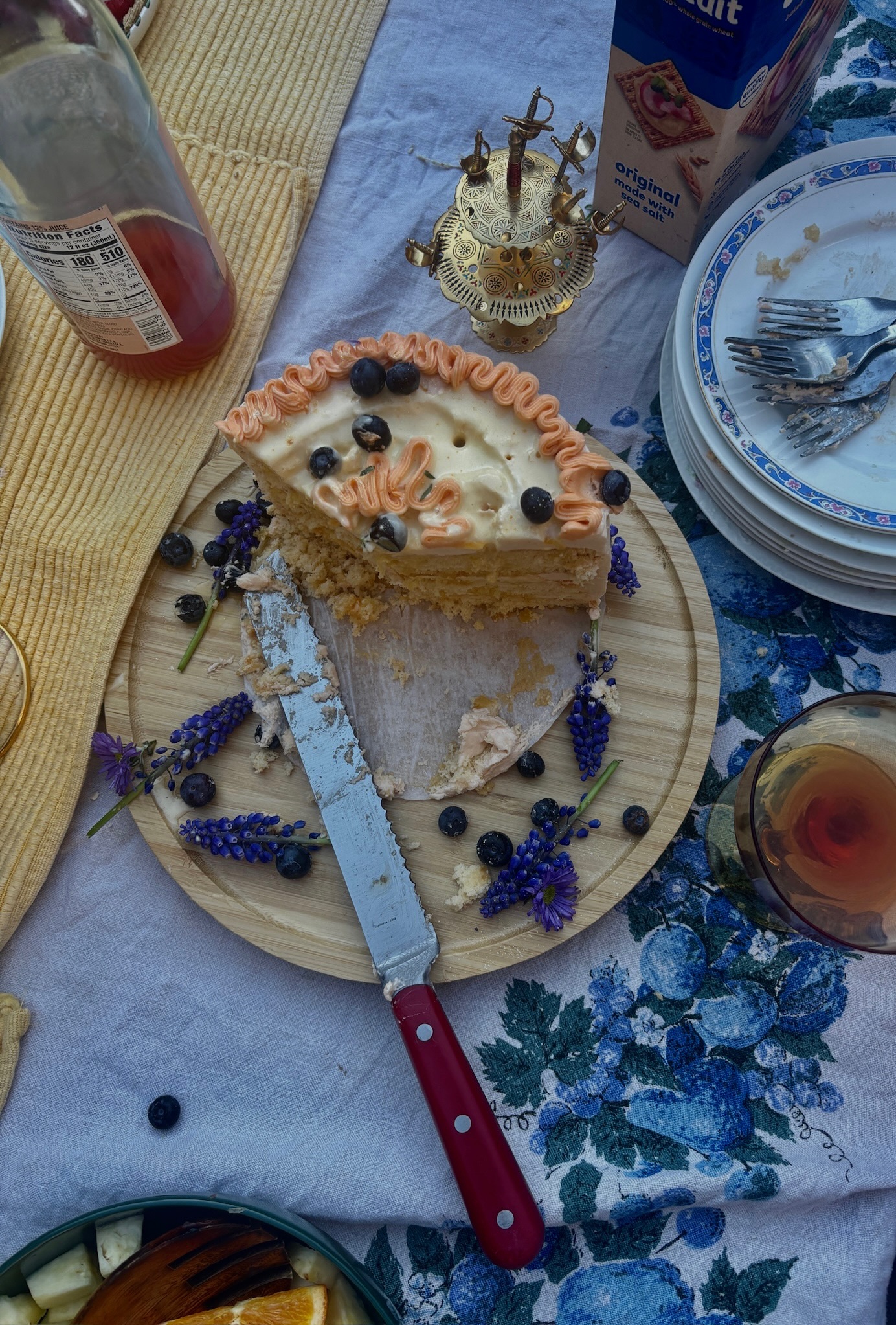Picnic scene with sliced cake, blueberries and lavender