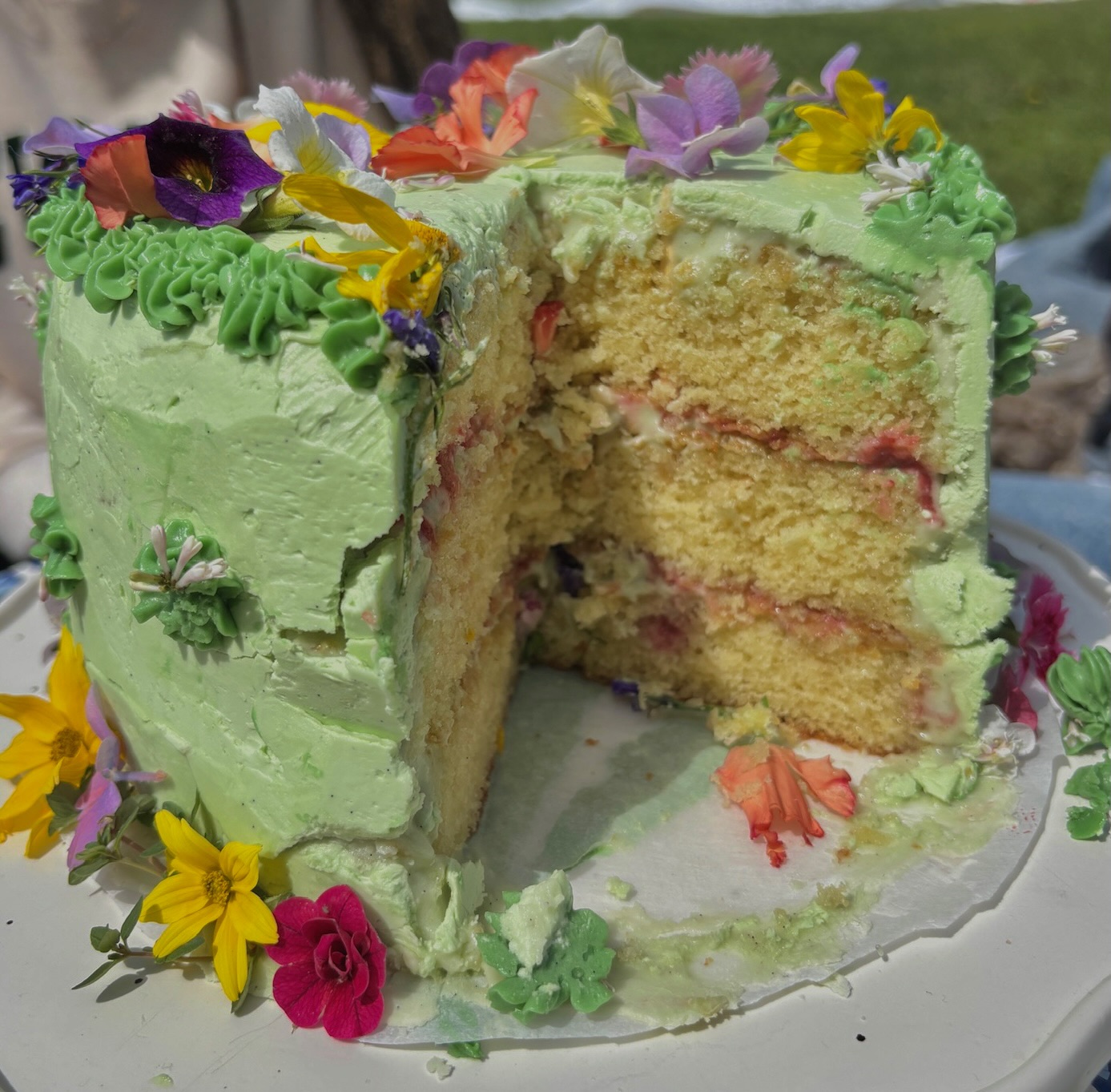 Green flower cake with slice showing layered interior